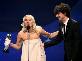 Lady Gaga (L) and Anthony Rossomando accept the Best Song award for 'Shallow' from 'A Star Is Born' onstage during the 24th annual Critics' Choice Awards at Barker Hangar on January 13, 2019 in Santa Monica, California.