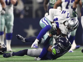 Allen Hurns of the Dallas Cowboys suffers a leg injury while tackled by Bradley McDougald of the Seattle Seahawks in the first quarter of the Wild Card Round at AT&T Stadium on Jan. 5, 2019 in Arlington, Texas. (Ronald Martinez/Getty Images)