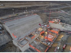 Completed powerhouse foundation, a massive concrete structure on the south bank.