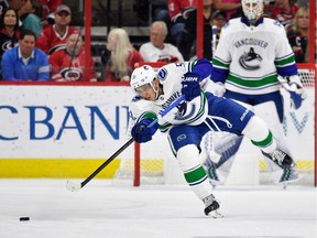Troy Stecher of the Vancouver Canucks sends a pass up the ice during a game against the Carolina Hurricanes at PNC Arena on October 9, 2018 in Raleigh, North Carolina.