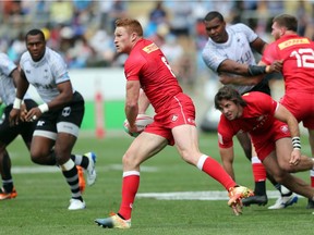Canada's Connor Braid looks to pass the ball out the back line during the World Rugby Sevens Series match between Fiji and Canada at Waikato Stadium in Hamilton on January 27, 2019.