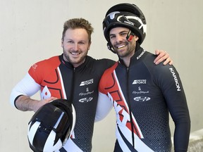 Canada's Justin Kripps, left and Cameron Stones pose for cameras after the second run of the two-man Bobsled World Cup race in Igls, near Innsbruck, Austria, Saturday, Jan. 19, 2019.