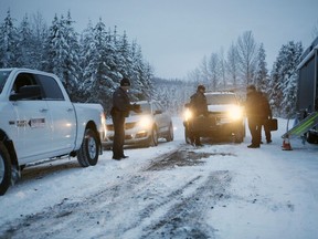 RCMP officers switch between shifts near their roadblock as supporters of the Unist'ot'en camp and Wet'suwet'en First Nation gather at a camp fire off a logging road near Houston on Wednesday, Jan. 9, 2019.