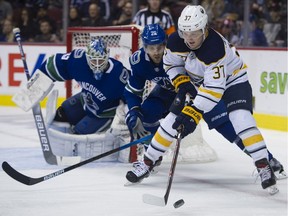 Casey Mittelstadt is chased by Vancouver Canucks' Brandon Sutter in front of the Canucks net in the second period. While accumulating high draft picks has made Buffalo better, it hasn't quite made them good enough, and it's been a long rebuild already.