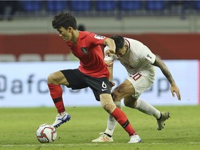 South Korea's midfielder Hwang In-beom, left, controls the ball during the AFC Asian Cup group C soccer match between South Korea and Philippines at Al Maktoum Stadium in Dubai, United Arab Emirates, Monday, Jan. 7, 2019.