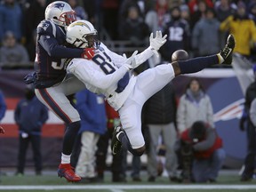 New England Patriots defensive back Devin McCourty, left, breaks up a pass intended for Los Angeles Chargers wide receiver Mike Williams during the first half of an NFL divisional playoff football game, Sunday, Jan. 13, 2019, in Foxborough, Mass.