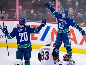 Adam Gaudette, back right, and Brandon Sutter, left, celebrate Gaudette's goal in January.