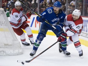 Vancouver Canucks' defenceman Chris Tanev, who has logged a lot of minutes this NHL season, battles for puck possession with Justin Williams of the Carolina Hurricanes during Wednesday's NHL action at Rogers Arena. The Hurricanes whipped the Canucks 5-2.