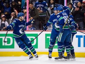 Vancouver Canucks' Ben Hutton, from left to right, Loui Eriksson, Jay Beagle and Tyler Motte celebrate Eriksson's goal against the Florida Panthers during the second period of an NHL hockey game in Vancouver, on Jan. 13.