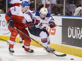 Quinn Hughes of Team USA battles for puck possession with Czech Republic's Jakub Lauko during IIHF world junior quarter-final hockey action in Victoria on Wednesday.