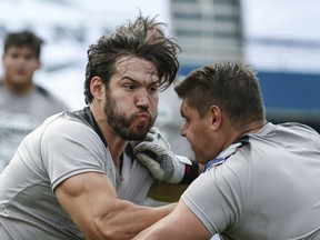 Defensive end Octavia Gonzalez pushes against an offensive lineman during a Canadian Football League scouting draft in Mexico City on Jan. 13, 2019. Athletes in Mexico are trying out for spots in the CFL.