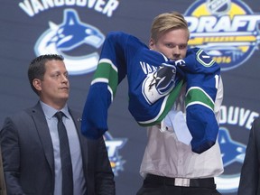 Judd Brackett, left, is the Canucks' director of amateur scouting.