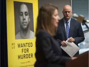 A $100,000 reward is being offered by the Combined Forces Special Enforcement Unit, in partnership with the Bolo Program and Crime Stoppers, for the arrest of Lower Mainland gangster Conor D'Monte. D'Monte is thought to be in Southeast Asia after fleeing several years ago. Pictured is Chief Superintendent Trent Rolfe, CFSEU chief officer, listening to Linda Annis, executive director of Metro Vancouver Crime Stoppers, on Wednesday.