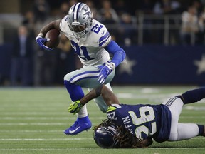 Dallas Cowboys running back Ezekiel Elliott (21) runs near Seattle Seahawks cornerback Shaquill Griffin (26) during the second half of the NFC wild-card NFL football game in Arlington, Texas, Saturday, Jan. 5, 2019.