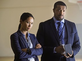 Detectives Taylor Chung (Alli Chung) and "Mac" McAvoy (Roger Cross) in a scene from the new CBC series Coroner. Photo: Ben Mark Holzberg
