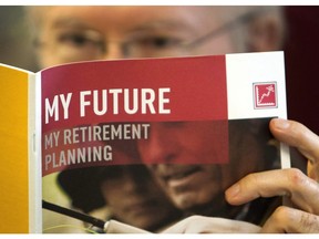 A man looks over a brochures offering various retirement savings options Friday, February 3, 2012 in Montreal.