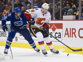 Alexander Edler chases Michael Ferland in a 2017 game. Ferland was traded by Calgary to Carolina in 2018.