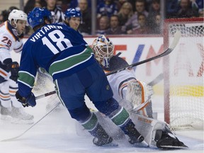 Vancouver Canucks Jake Virtanen sprays Edmonton Oiler goalie Mikko Koskinen during the first period.