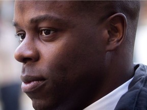 RCMP Const. Kwesi Millington leaves court during a lunch break at his perjury trial in Vancouver, B.C., on Monday March 10, 2014.