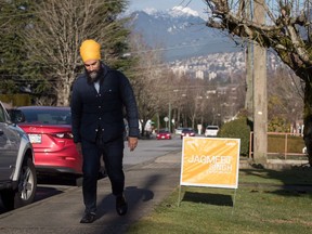 NDP Leader Jagmeet Singh walks to another home after placing a sign on supporter Paul Pelletreau's lawn while door knocking for his byelection campaign, in Burnaby, B.C. on Saturday January 12, 2019. Inside a sunlit co-operative housing complex in Burnaby, B.C., federal NDP Leader Jagmeet Singh recently knocked on doors of residents whose first languages included Croatian, Filipino and Spanish. Often to their surprise, Singh greeted them or said goodbye in their mother tongue.