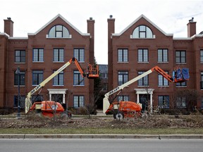 Boom lifts sit in front of homes in the Glen housing development in Glenview, Illinois, U.S.
