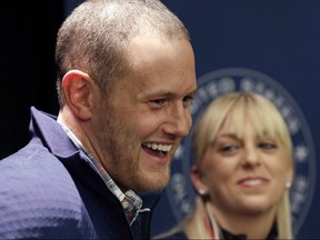 In this an Oct. 1, 2013, file photo, U.S. figure skating pairs John Coughlin (left) and Caydee Denney (right) speak with reporters during a news conference in Park City, Utah.