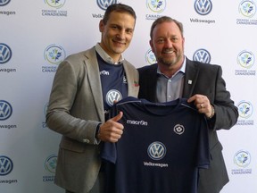 Canadian Premier League commissioner David Clanachan (right) and Volkswagen Group Canada president Daniel Weissland hold up a soccer jersey at a CPL event in Toronto, Tuesday, Jan.29, 2019. VW signed on as the league's first founding sponsor.