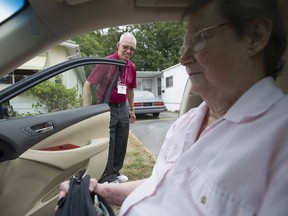 George Garrett helps Karon Peers get into Garrett's car before he takes her to a doctor appointment.