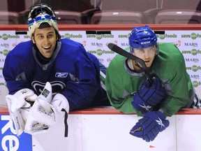 Chris Tanev can't say enough good things about goaltender and former teammate Roberto Luongo, left, who will play for the Florida Panthers on Sunday against the Vancouver Canucks at Rogers Arena.