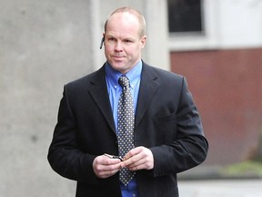 Former police officer Derek Brassington arrives at B.C. Provincial Court in Vancouver Dec. 11, 2013.