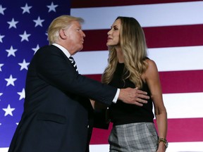 President Donald Trump, left, embraces his daughter-in-law Lara Trump, right, who introduced him at a Republican fundraiser at the Carmel Country Club in in Charlotte, N.C., Friday, Aug. 31, 2018.
