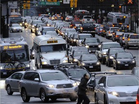 Cars make their way along downtown Vancouver's Georgia Street.