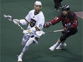 Vancouver Warriors' Keegan Bal is chased by Colorado Mammoth's Scott Carnegie during an NLL lacrosse game at Rogers Arena on Saturday.