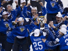 Team Finland celebrates as Aarne Talvitie (centre) lifts the trophy after beating Team USA in the gold-medal game at the 2019 IIHF World Junior Championship at Rogers Arena in Vancouver Saturday.