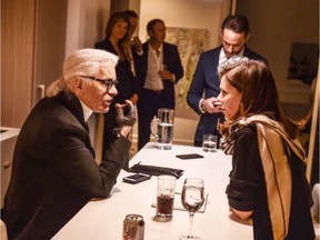 Noreen Flanagan, the editor-in-chief of Fashion magazine, interviews Karl Lagerfeld in this undated handout photo.