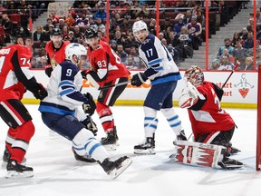Senators goalie Anders Nilsson makes a trapper save against Andrew Copp of the Winnipeg Jets during Ottawa's 5-2 win at the Canadian Tire Centre Saturday.