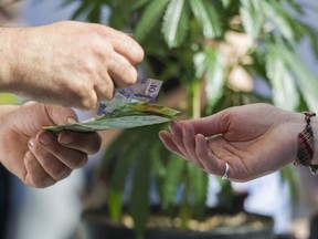 Money changes hands at a vendor in the market of the annual 420 marijuana event at it's new location, Sunset Beach, Vancouver April 20 2016.