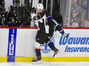 Giants defenceman Bowen Byram lays a big hit during Vancouver's 4-0 win over the Victoria Royals Friday night.