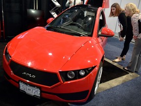 Showgoers check out an Electra Meccanica Solo at CES 2018 earlier this week in Las Vegas.