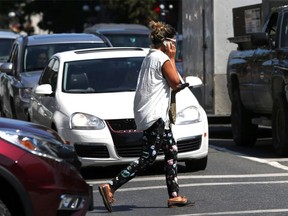 Distracted walking may have played a part in an incident in Surrey that sent a pedestrian to hospital with head injuries. A file photo of a cellphone-using pedestrian crosses Douglas Street in Victoria on Monday, July 18, 2016.