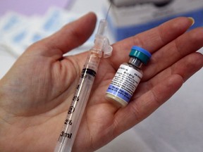 A nurse prepares a combined vaccine for measles, mumps and rubella.