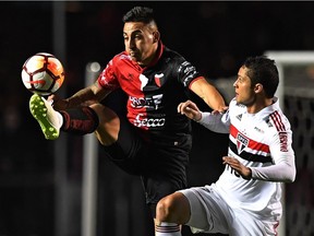 Colon's Erik Godoy, left, battles with Anderson Martins of Brazil's Sao Paulo during their 2018 Copa Sudamericana football match held at Morumbi stadium in Sao Paulo, Brazil last August.