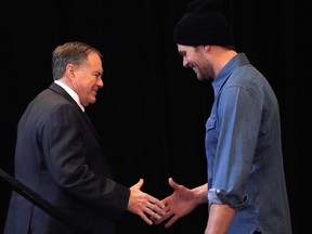 New England Patriots quarterback Tom Brady, right, greets head coach Bill Belichick during a media availability at the Super Bowl Media Center at the World Congress Center in Atlanta, Georgia on Thursday. The New England Patriots play the Los Angeles Ram in Super Bowl 53 on Sunday.