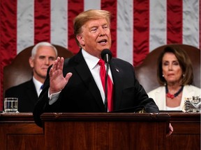 US President Donald Trump delivers the State of the Union address, alongside Vice President Mike Pence and Speaker of the House Nancy Pelosi, at the US Capitol in Washington, DC, on February 5, 2019.