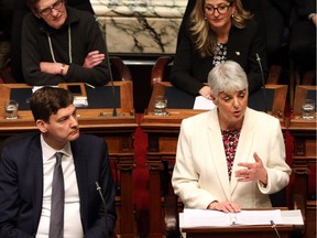Attorney-General David Eby looks on as Finance Minister Carole James delivers the budget speech at the legislature in Victoria on Feb. 19.