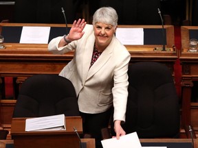 Finance Minister Carole James arrives to deliver the budget speech as she waves to people in the gallery at the legislature in Victoria, B.C., on Tuesday, February 19, 2018.