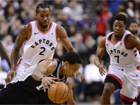 San Antonio Spurs guard DeMar DeRozan (10) loses the the ball under pressure from Toronto Raptors forward Kawhi Leonard (2) with 15 seconds left in the game during second half NBA basketball action in Toronto on Friday, Feb. 22, 2019.