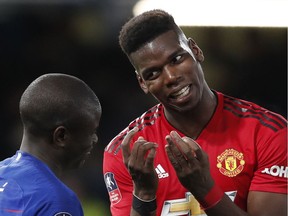 Manchester United's Paul Pogba (right) jokes with Chelsea's N'Golo Kante after their English FA Cup fifth-round match at Stamford Bridge stadium in London on Monday, Feb. 18, 2019. Man United shut out Chelsea 2-0.