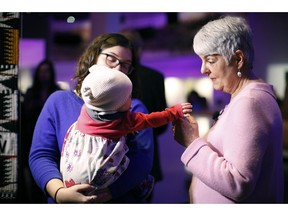 Finance Minister Carole James meets with Sam Montgomery and her daughter MJ as they tour the Our Living Languages exhibit at the Royal B.C. Museum in Victoria, B.C., on Monday, February 18, 2019.