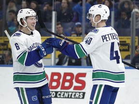 Troy Stecher knows his primary job on the power play is getting the puck to shooters Brock Boeser (left) or Elias Pettersson (right). (Photo: Jeff Roberson, Associated Press files)
